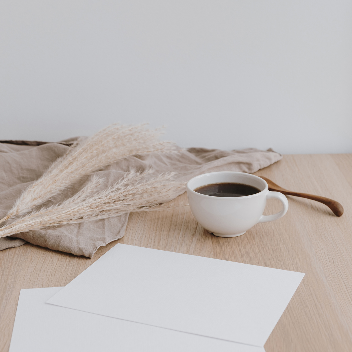 Cup of Coffee with Papers on Wooden Table